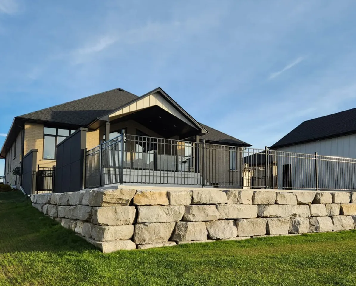 house with stone deck and metal railings